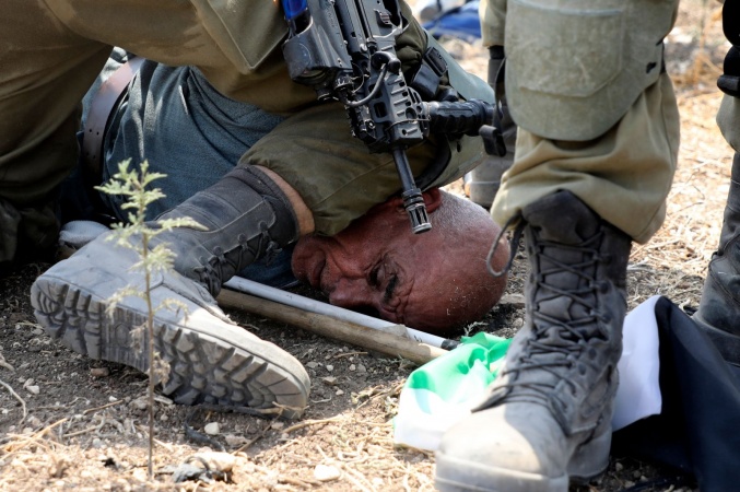 Israeli soldier kneels on Palestinian protester's neck: video 